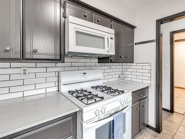 535 N Patchin Ave, Shawnee, OK 74801 - kitchen with white appliances, tasteful backsplash, light tile patterned floors, and dark brown cabinets