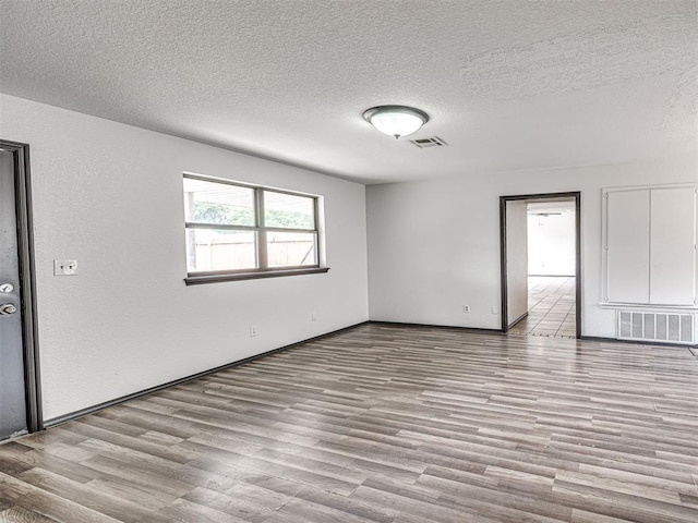 535 N Patchin Ave, Shawnee, OK 74801 - unfurnished room featuring a textured ceiling and wood finished floors