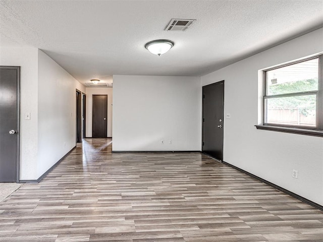 535 N Patchin Ave, Shawnee, OK 74801 - spare room with wood finished floors and a textured ceiling
