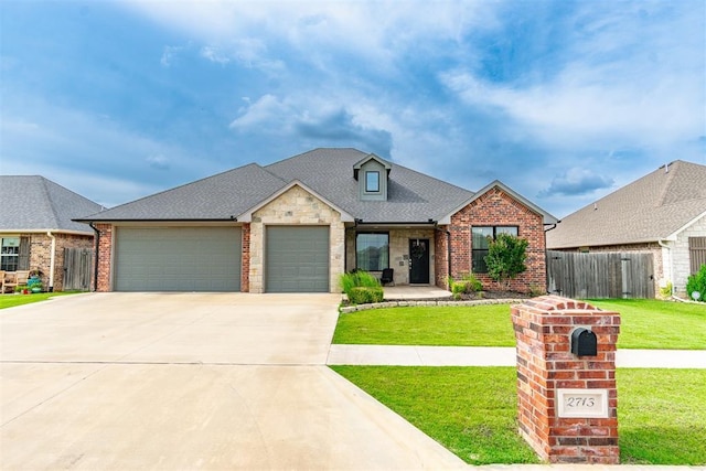2713 Falling Leaves Dr, Weatherford, OK 73096 - view of front of home with an attached garage, driveway, brick siding, and a shingled roof