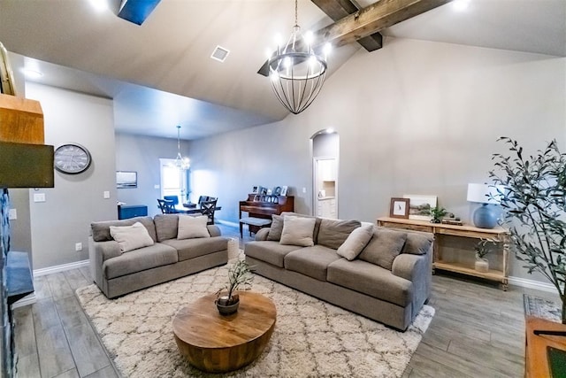2713 Falling Leaves Dr, Weatherford, OK 73096 - living room featuring a chandelier, arched walkways, wood finished floors, beamed ceiling, and high vaulted ceiling