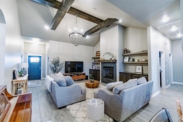 2713 Falling Leaves Dr, Weatherford, OK 73096 - living area with wood finished floors, a chandelier, a fireplace, and arched walkways