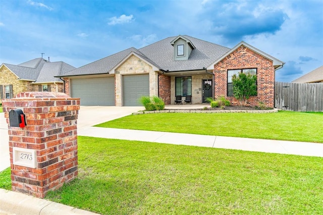 2713 Falling Leaves Dr, Weatherford, OK 73096 - view of front of house featuring a garage, driveway, stone siding, brick siding, and roof with shingles