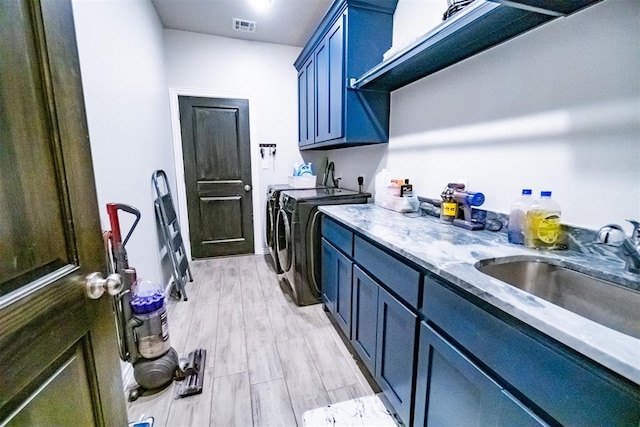 2713 Falling Leaves Dr, Weatherford, OK 73096 - laundry room with separate washer and dryer, cabinet space, and light wood-style flooring
