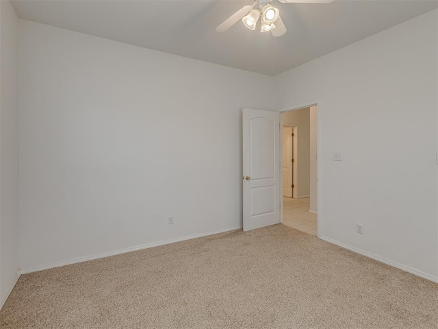 4919 E Lone Chimney Rd, Glencoe, OK 74032 - unfurnished room featuring light carpet and a ceiling fan