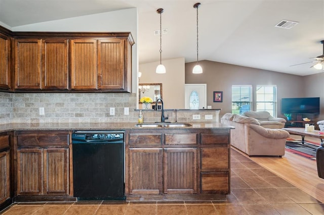 1609 NW 144th Ter, Edmond, OK 73013 - kitchen with black dishwasher, vaulted ceiling, a ceiling fan, stone countertops, and backsplash