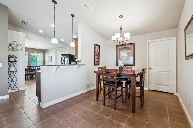 1609 NW 144th Ter, Edmond, OK 73013 - dining room with a chandelier, lofted ceiling, and dark tile patterned floors