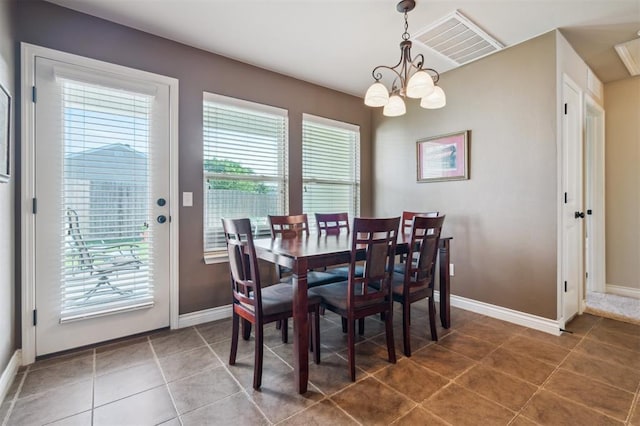 1609 NW 144th Ter, Edmond, OK 73013 - tiled dining area featuring a chandelier and healthy amount of natural light