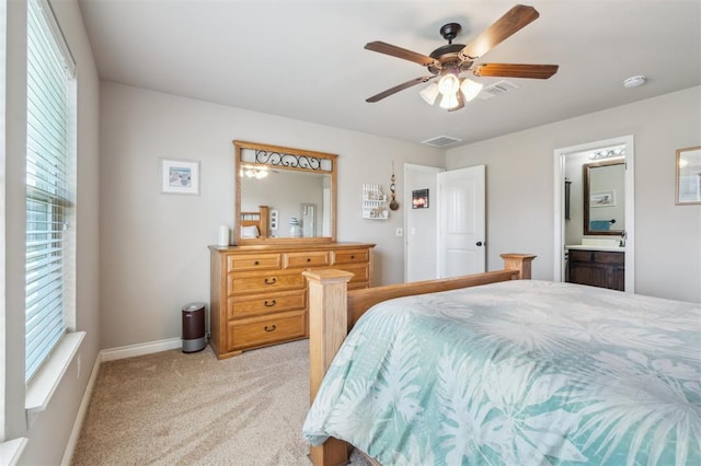 1609 NW 144th Ter, Edmond, OK 73013 - bedroom with light colored carpet, ceiling fan, and ensuite bathroom