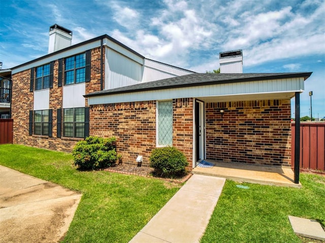 3003 River Oaks Dr Unit 119, Norman, OK 73072 - view of front of home featuring a chimney and brick siding