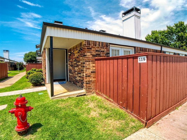 3003 River Oaks Dr Unit 119, Norman, OK 73072 - view of property exterior with a chimney and brick siding