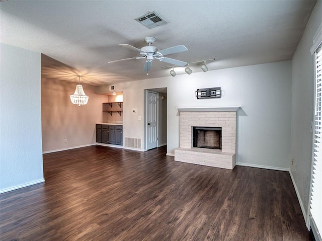 3003 River Oaks Dr Unit 119, Norman, OK 73072 - unfurnished living room featuring a ceiling fan, a fireplace, wood finished floors, and track lighting