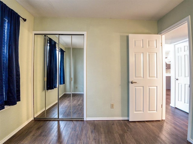 3003 River Oaks Dr Unit 119, Norman, OK 73072 - unfurnished bedroom with wood finished floors and a closet