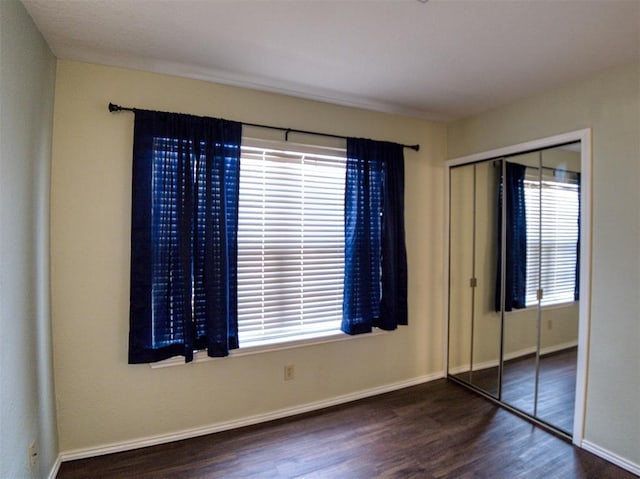 3003 River Oaks Dr Unit 119, Norman, OK 73072 - unfurnished bedroom featuring wood finished floors and a closet