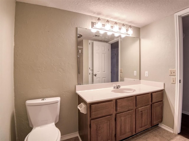 3003 River Oaks Dr Unit 119, Norman, OK 73072 - bathroom featuring a textured ceiling, vanity, tile patterned floors, and a textured wall