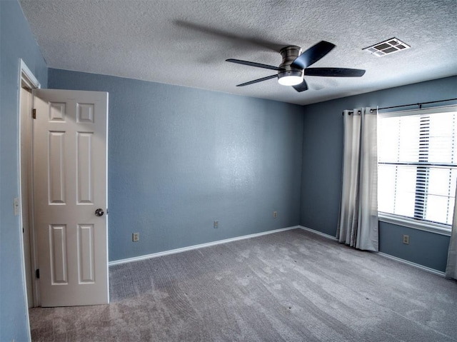 3003 River Oaks Dr Unit 119, Norman, OK 73072 - carpeted empty room with ceiling fan and a textured ceiling