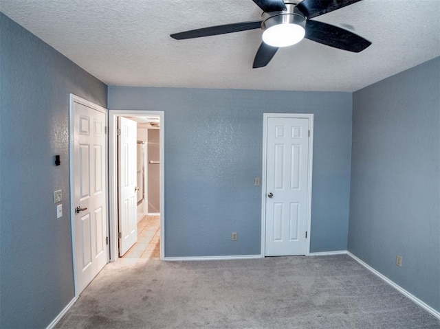 3003 River Oaks Dr Unit 119, Norman, OK 73072 - unfurnished bedroom featuring carpet flooring, a textured ceiling, a textured wall, and a ceiling fan