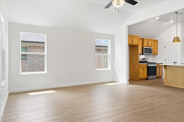 3825 NW 176th St, Edmond, OK 73012 - kitchen with appliances with stainless steel finishes, a ceiling fan, lofted ceiling, open floor plan, and light wood finished floors