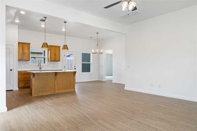 3825 NW 176th St, Edmond, OK 73012 - kitchen featuring open floor plan, light countertops, a center island, ceiling fan, and a chandelier