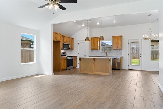 3825 NW 176th St, Edmond, OK 73012 - kitchen with stainless steel appliances, lofted ceiling, tasteful backsplash, ceiling fan, and a center island