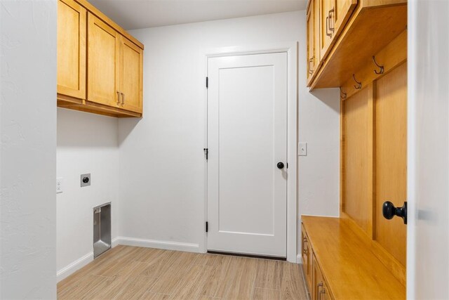 3825 NW 176th St, Edmond, OK 73012 - laundry area with electric dryer hookup, light wood-style floors, and cabinet space