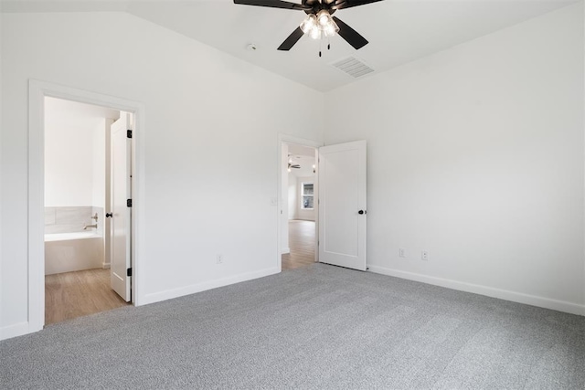 3825 NW 176th St, Edmond, OK 73012 - unfurnished bedroom with light carpet, vaulted ceiling, ensuite bathroom, and a ceiling fan