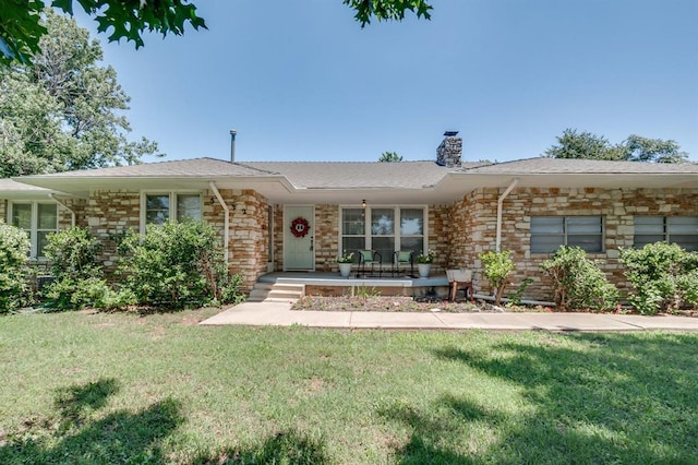 5932 N Grove Ave, Oklahoma City, OK 73122 - view of front of home with a chimney, a porch, a front yard, and stone siding