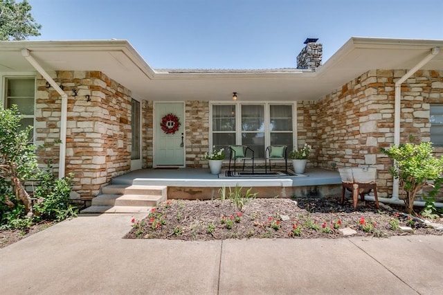 5932 N Grove Ave, Oklahoma City, OK 73122 - entrance to property with a porch, a chimney, and stone siding