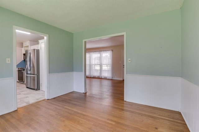 5932 N Grove Ave, Oklahoma City, OK 73122 - empty room with wainscoting and wood finished floors