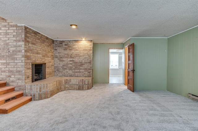 5932 N Grove Ave, Oklahoma City, OK 73122 - unfurnished living room featuring carpet floors, a brick fireplace, a textured ceiling, stairs, and wood walls