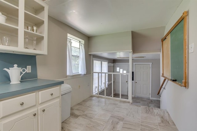 5932 N Grove Ave, Oklahoma City, OK 73122 - kitchen with white cabinets and light marble finish flooring