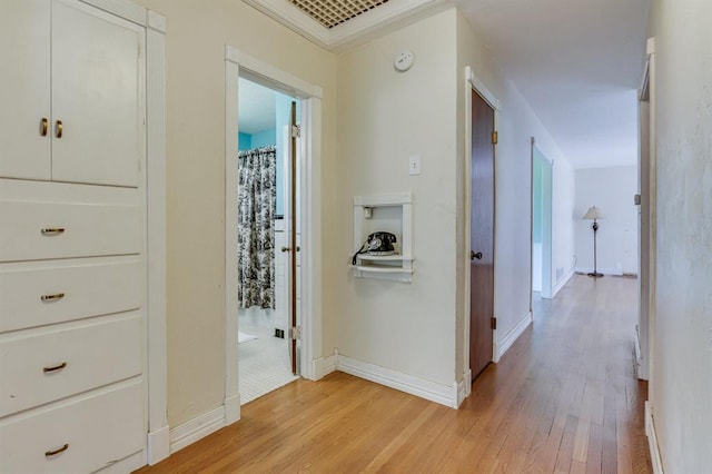 5932 N Grove Ave, Oklahoma City, OK 73122 - corridor featuring light wood finished floors and crown molding