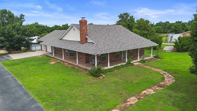 813 N Council Rd Unit S, Newcastle, OK 73065 - view of front of property featuring a porch, a chimney, a front lawn, driveway, and a garage