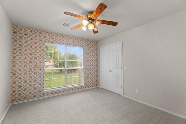 813 N Council Rd Unit S, Newcastle, OK 73065 - unfurnished bedroom featuring carpet floors, wallpapered walls, a closet, and ceiling fan