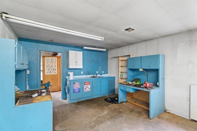 813 N Council Rd Unit S, Newcastle, OK 73065 - kitchen featuring blue cabinetry and concrete flooring