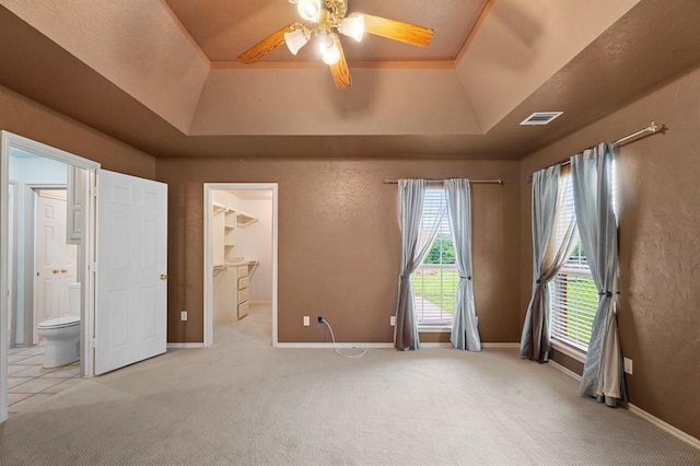 813 N Council Rd Unit S, Newcastle, OK 73065 - unfurnished bedroom with a tray ceiling, carpet flooring, a spacious closet, a textured wall, and connected bathroom