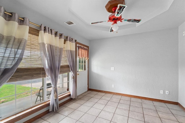 813 N Council Rd Unit S, Newcastle, OK 73065 - empty room featuring plenty of natural light, a ceiling fan, a textured wall, and light tile patterned floors