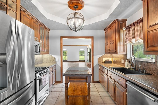 813 N Council Rd Unit S, Newcastle, OK 73065 - kitchen with appliances with stainless steel finishes, a chandelier, backsplash, and plenty of natural light