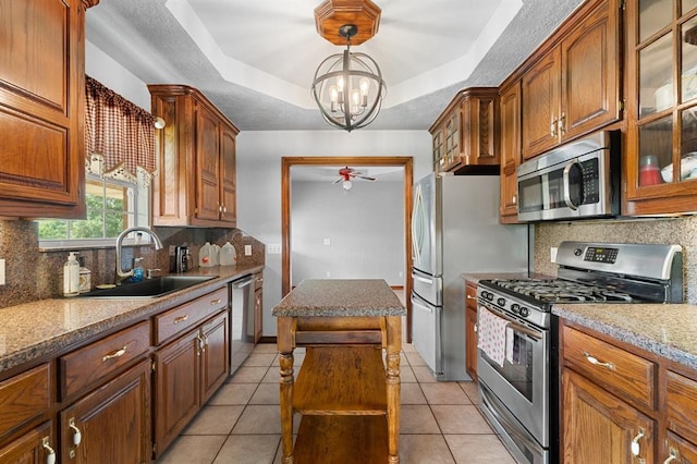 813 N Council Rd Unit S, Newcastle, OK 73065 - kitchen with appliances with stainless steel finishes, a raised ceiling, tasteful backsplash, and a kitchen island