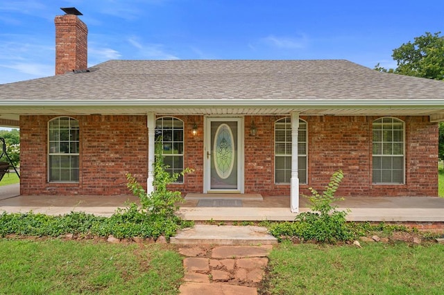 813 N Council Rd Unit S, Newcastle, OK 73065 - view of front of home featuring a porch, a shingled roof, a chimney, and brick siding