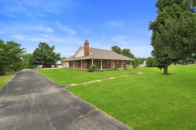 813 N Council Rd Unit S, Newcastle, OK 73065 - view of front of property with a chimney, covered porch, asphalt driveway, a front lawn, and a garage