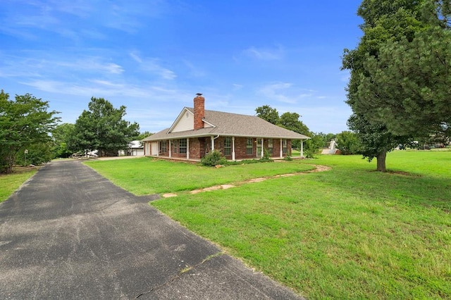 813 N Council Rd Unit S, Newcastle, OK 73065 - view of front of home featuring a chimney, a porch, a front lawn, and brick siding