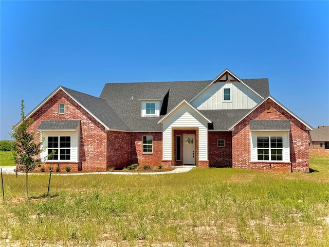4163 Hawthorne St, Piedmont, OK 73078 - view of front of property featuring brick siding, board and batten siding, a shingled roof, and a front yard