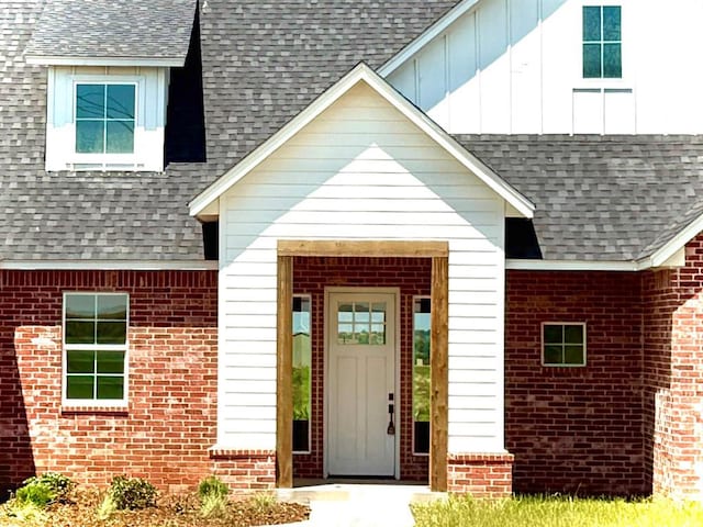 4163 Hawthorne St, Piedmont, OK 73078 - doorway to property with roof with shingles, brick siding, and board and batten siding