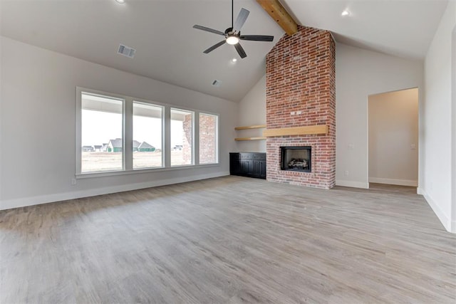 4163 Hawthorne St, Piedmont, OK 73078 - unfurnished living room with beamed ceiling, high vaulted ceiling, light wood-style floors, ceiling fan, and a fireplace