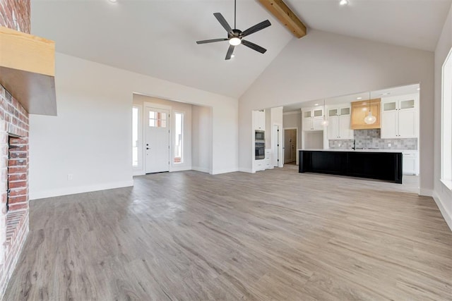 4163 Hawthorne St, Piedmont, OK 73078 - unfurnished living room with beamed ceiling, high vaulted ceiling, ceiling fan, and light wood-style floors