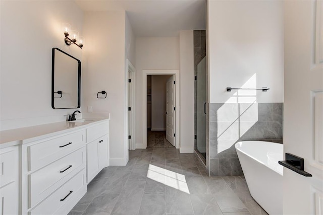4163 Hawthorne St, Piedmont, OK 73078 - full bathroom featuring vanity, a freestanding tub, a shower stall, marble look tiles, and tile walls