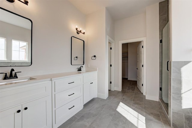 4163 Hawthorne St, Piedmont, OK 73078 - full bathroom with double vanity, a stall shower, a spacious closet, and marble look tiles