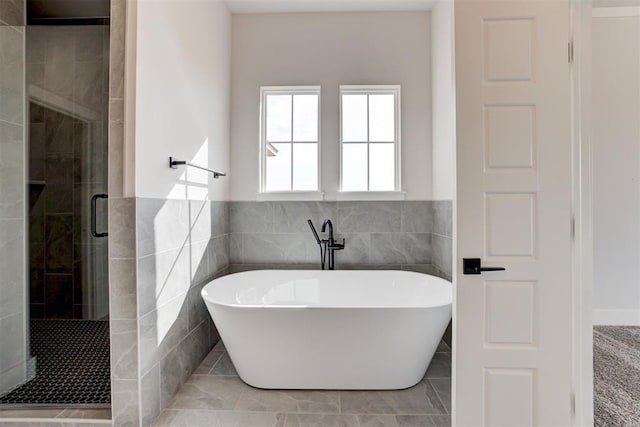 4163 Hawthorne St, Piedmont, OK 73078 - full bathroom with a stall shower, a soaking tub, tile walls, and a wainscoted wall