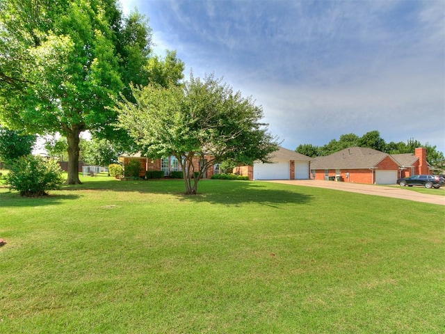 1204 Scrambler Ln, Edmond, OK 73025 - view of front of house featuring a front yard, brick siding, and driveway